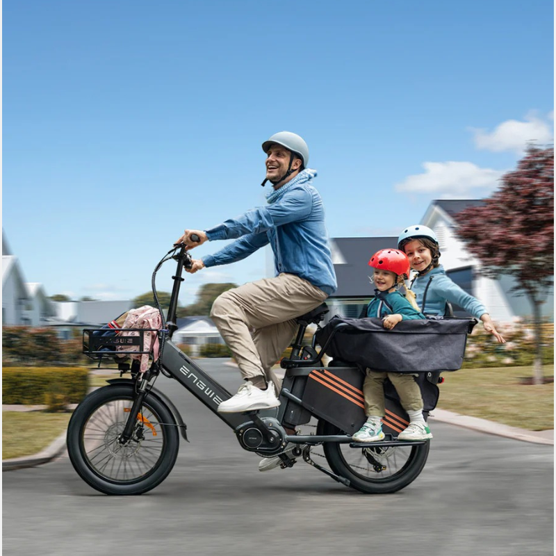 Man riding an Engwe LE20  with two children in a basket on a sunny day.