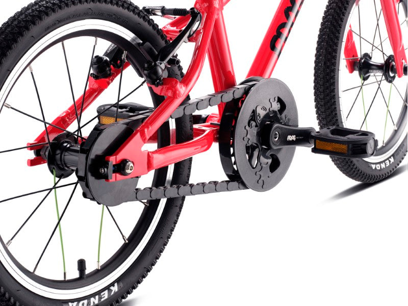 Close-up of a red bicycle showing its chainguard with white background 