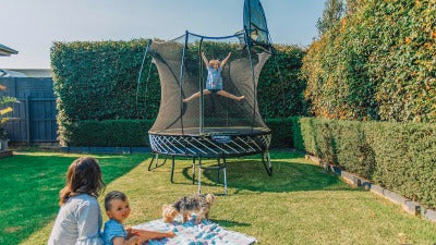 Springfree® 8ft Round Trampoline at Garden with Kid Jumping on it